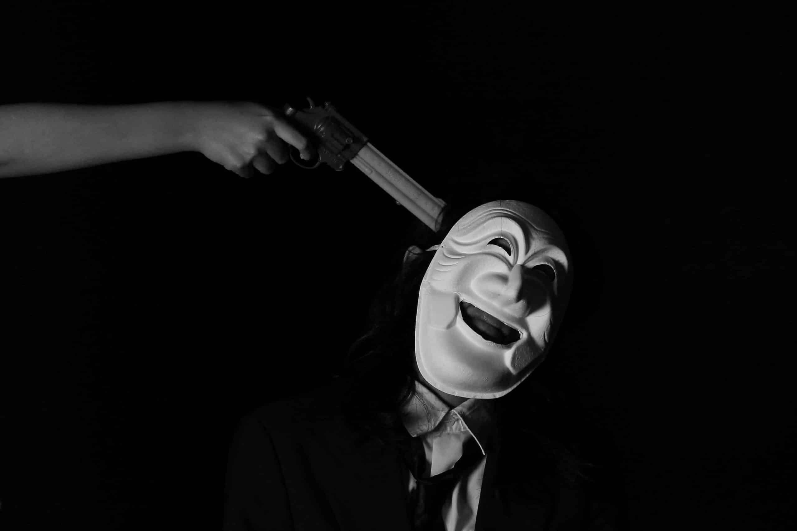 an image of a gun being pointed to a mask depiciting validity threats to an A/B test
