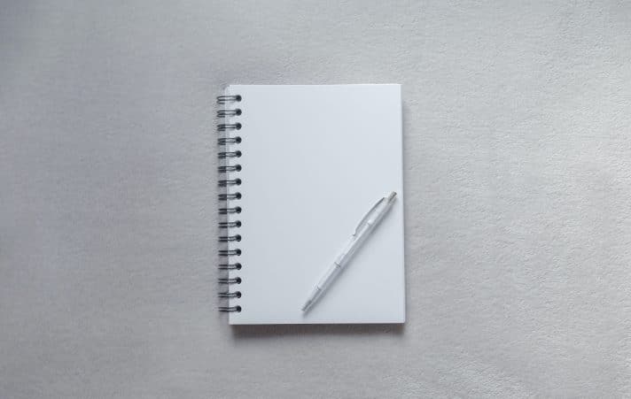 A pen and a plain sheet of paper to write down the checklist you must have as a business owner to optimize your landing page