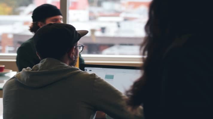 conversion rate optimization experts in a meeting discussing benchmarks for what it takes to successfully run a CRO program
