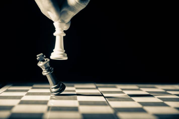 A chess board image where a king is being knocked down, trying to depict if conversion rate optimisation is better than CVO