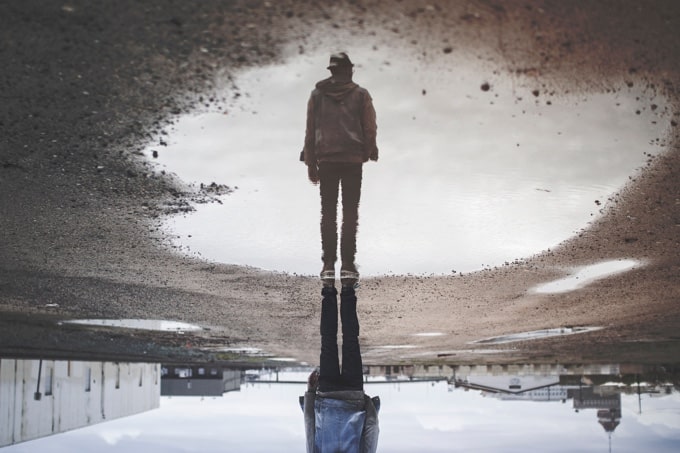 an image of a man that looks like a pool of water is over his head but in reality, he’s stepping on the water.