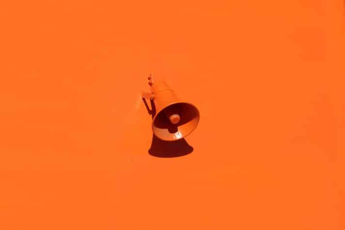 A orange background with an orange coloured megaphone which depicts being loud with your unique value proposition